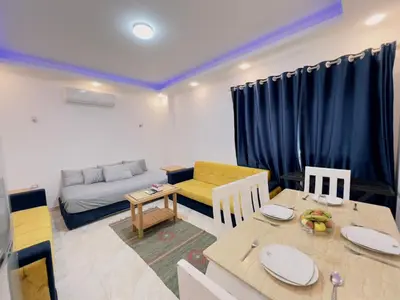 a living room with a table and a couch at selena bay resort in El Gouna