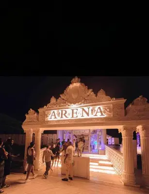 a group of people standing in front of a theatre at night at selena bay resort in El Gouna