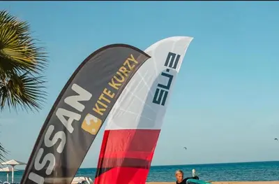 a man standing on the beach with two flags at selena bay resort in El Gouna