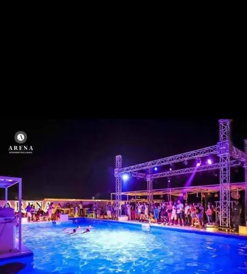 a large swimming pool at night with people in it at selena bay resort in El Gouna
