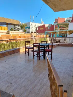 a patio with tables and chairs on a roof at AL Sarfi Apartments in Hurghada