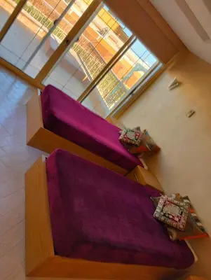 a room with three bunk beds with purple sheets at AL Sarfi Apartments in Hurghada