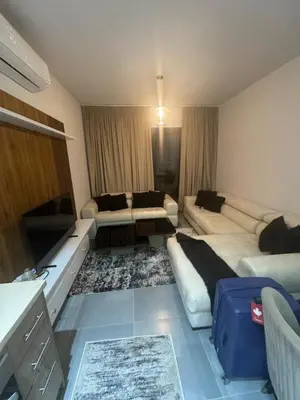 a living room with a couch and a tv in it at Luxury 3BD Makadi Heights phase 2 Orascom in Hurghada