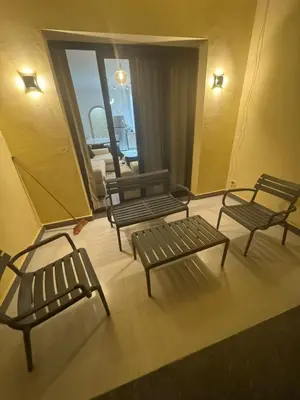 a group of benches in a room with a window at Luxury 3BD Makadi Heights phase 2 Orascom in Hurghada