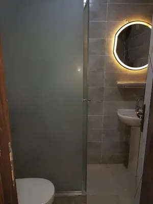 a bathroom with a toilet and a sink and a mirror at Taiba Golden Resort in Hurghada