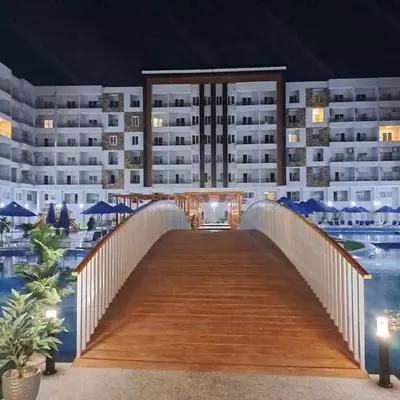 a bridge over a pool in front of a building at Taiba Golden Resort in Hurghada