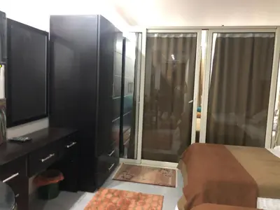 a bedroom with a bed and a large glass shower at scandic Resort hurghada in Hurghada