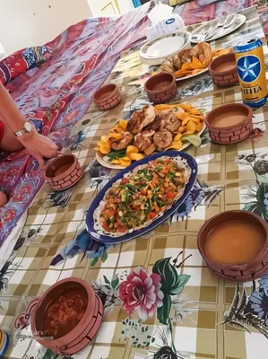 a table with plates of food on top at sailboat in Luxor