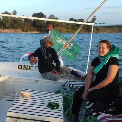 a man and a woman sitting on a boat at sailboat in Luxor