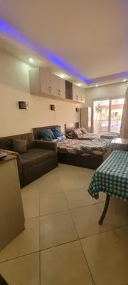 a living room with a bed and a couch at Apartment With Free Private Beach Furnished Near senzomall in Hurghada