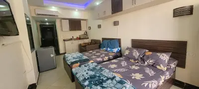 a small living room with a couch and a bed at Apartment With Free Private Beach Furnished Near senzomall in Hurghada