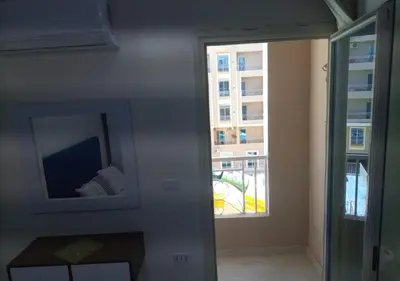 a room with a mirror and a window at -Hurghada HUB Resort-Peaceful Getaway in Hurghada