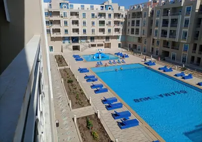 an overhead view of a swimming pool with lounge chairs at -Hurghada HUB Resort-Peaceful Getaway in Hurghada