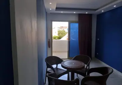 a room with a table and chairs and a window at Fanadir Bay - beach & Aquapark in Hurghada
