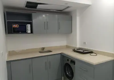 a kitchen with a sink and a washing machine at Fanadir Bay - beach & Aquapark in Hurghada