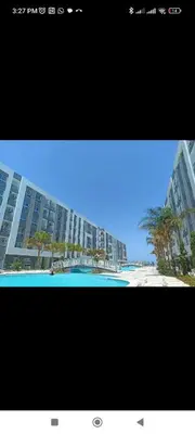 a picture of a beach and a large building at Hurghada Fanader bay in Hurghada