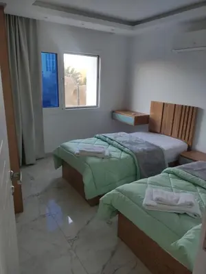 a hotel room with two beds and a window at Hurghada Fanader bay in Hurghada