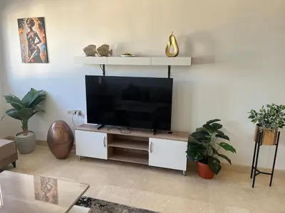 a living room with a large flat screen tv at Seaview Apartment in Azzurra Sahl Hasheesh 2 bedrooms in Hurghada