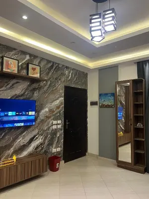 a lobby with a black door and a tv on a wall at Sunflower cozy apartment in Hurghada