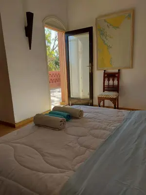 a large bed in a room with an open door at فيلا نوبيا بجوار بيتش الزيتونه in Hurghada