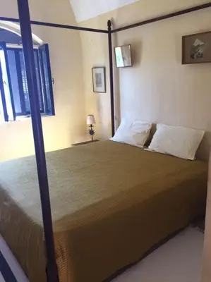 a bedroom with a large bed in a room at فيلا نوبيا بجوار بيتش الزيتونه in Hurghada