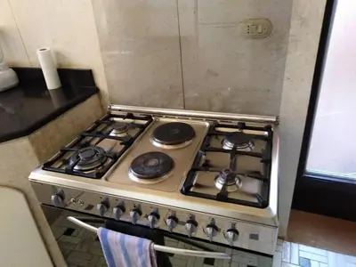 a stove top oven sitting in a kitchen at فيلا نوبيا بجوار بيتش الزيتونه in Hurghada