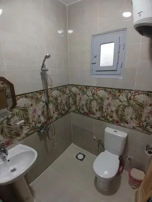 a bathroom with a toilet and a sink at Hakuna Matata in Aswan