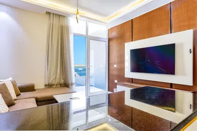a living room with a tv and a couch at La Prestigia luxury Apartments by Peaks in Hurghada