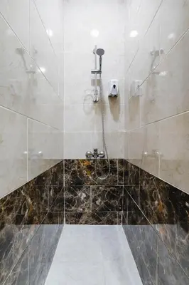 a bathroom with a shower with a glass door at La Prestigia luxury Apartments by Peaks in Hurghada