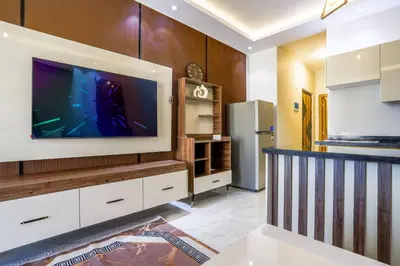 a kitchen with a large flat screen tv on a wall at La Prestigia luxury Apartments by Peaks in Hurghada