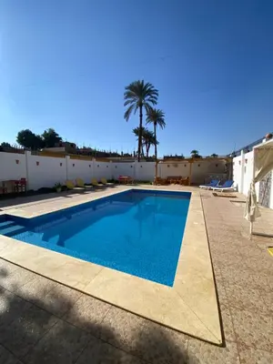 a swimming pool in the middle of a building at Villa Acamar in Al Karnak