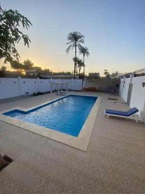 a swimming pool on the roof of a house at Villa Acamar in Al Karnak