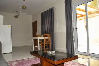 a living room with a black table and a window at Villa Acamar in Al Karnak