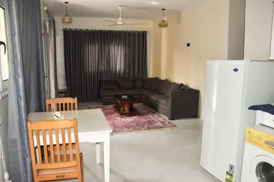a living room with a couch and a table at Villa Acamar in Al Karnak