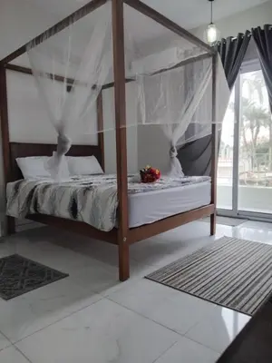 a bedroom with a canopy bed in a room at Villa Acamar in Al Karnak