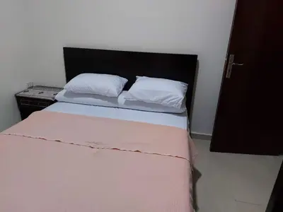 a bedroom with a bed with white sheets and pillows at Casablanca beach in Hurghada