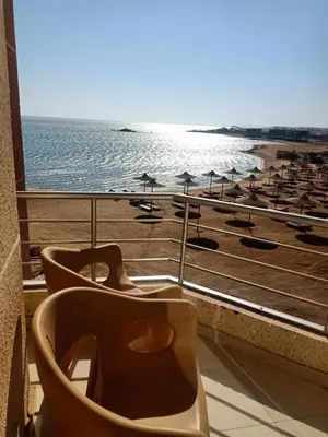 a bathroom with a view of a beach with umbrellas at Casablanca beach in Hurghada