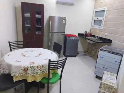 a kitchen with a table and a refrigerator at Casablanca beach in Hurghada