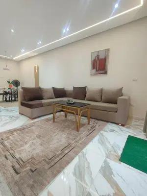 a living room with a couch and a table at red ruby Comfort in Hurghada