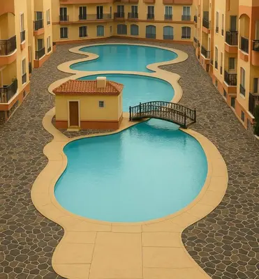 a row of swimming pools in an apartment complex at red ruby Comfort in Hurghada
