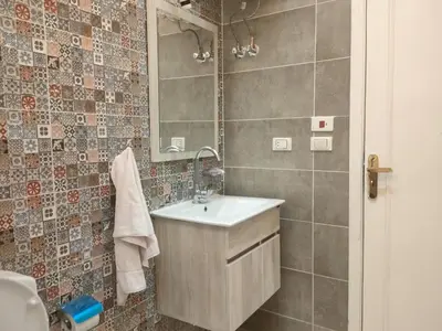 a bathroom with a sink and a mirror at red ruby Comfort in Hurghada