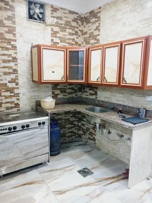 a kitchen with a sink and a stove at Hotel apartments in Hurghada