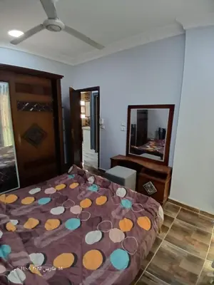 a bedroom with a bed and a mirror at Hotel apartments in Hurghada