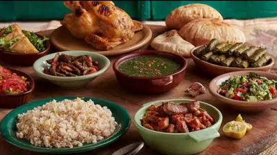 a table topped with bowls of different types of food at El Bawaba Lodge & Luxury Retreat in Al Aqālitah