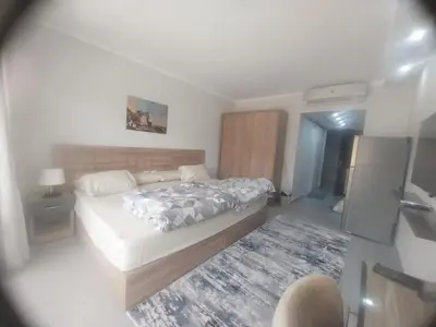 a bedroom with a large bed and a rug at pola studio at scandic resort in Hurghada