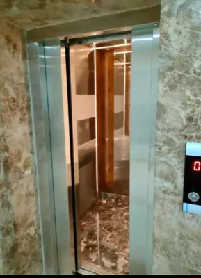 a glass elevator with a door in a room at pola studio at scandic resort in Hurghada