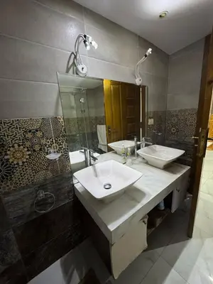 a bathroom with two sinks and a shower at Villa 348 Jamaran - Sahl Hasheesh in Hurghada
