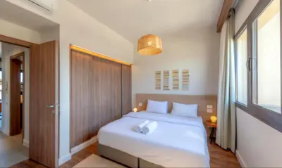 a bedroom with a white bed and a window at Luxury Stays in Fanadir Marina El Gouna in Hurghada