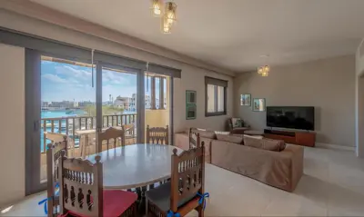 a living room with a table and a couch at Luxury Stays in Fanadir Marina El Gouna in Hurghada