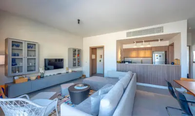 a living room with a couch and a kitchen at Luxury Stays in Fanadir Marina El Gouna in Hurghada